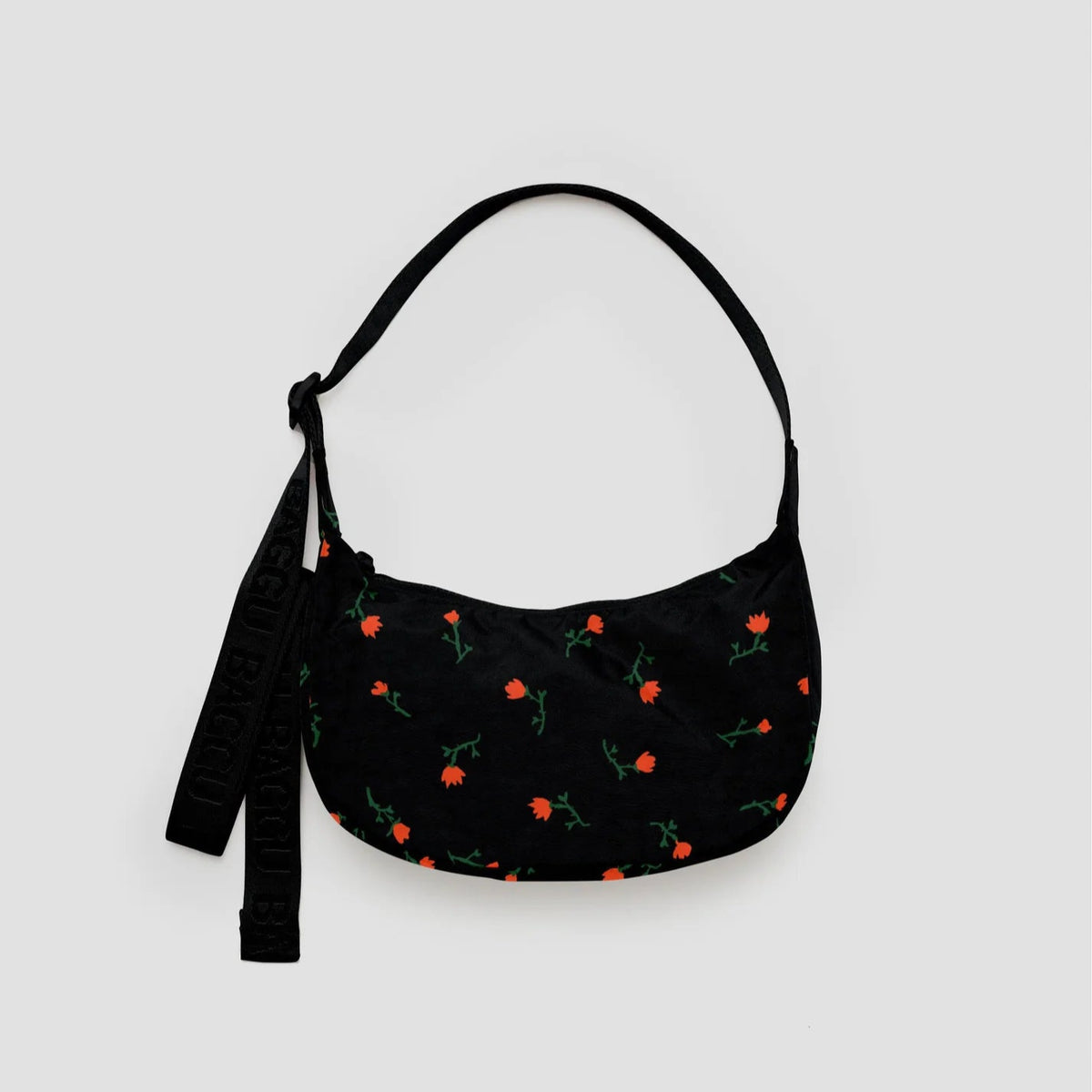 Black handbag with floral pattern on a light gray background