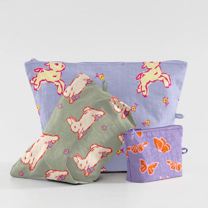 Three fabric bags with animal patterns on a light gray background