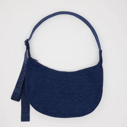 Navy blue purse with a strap on a white background