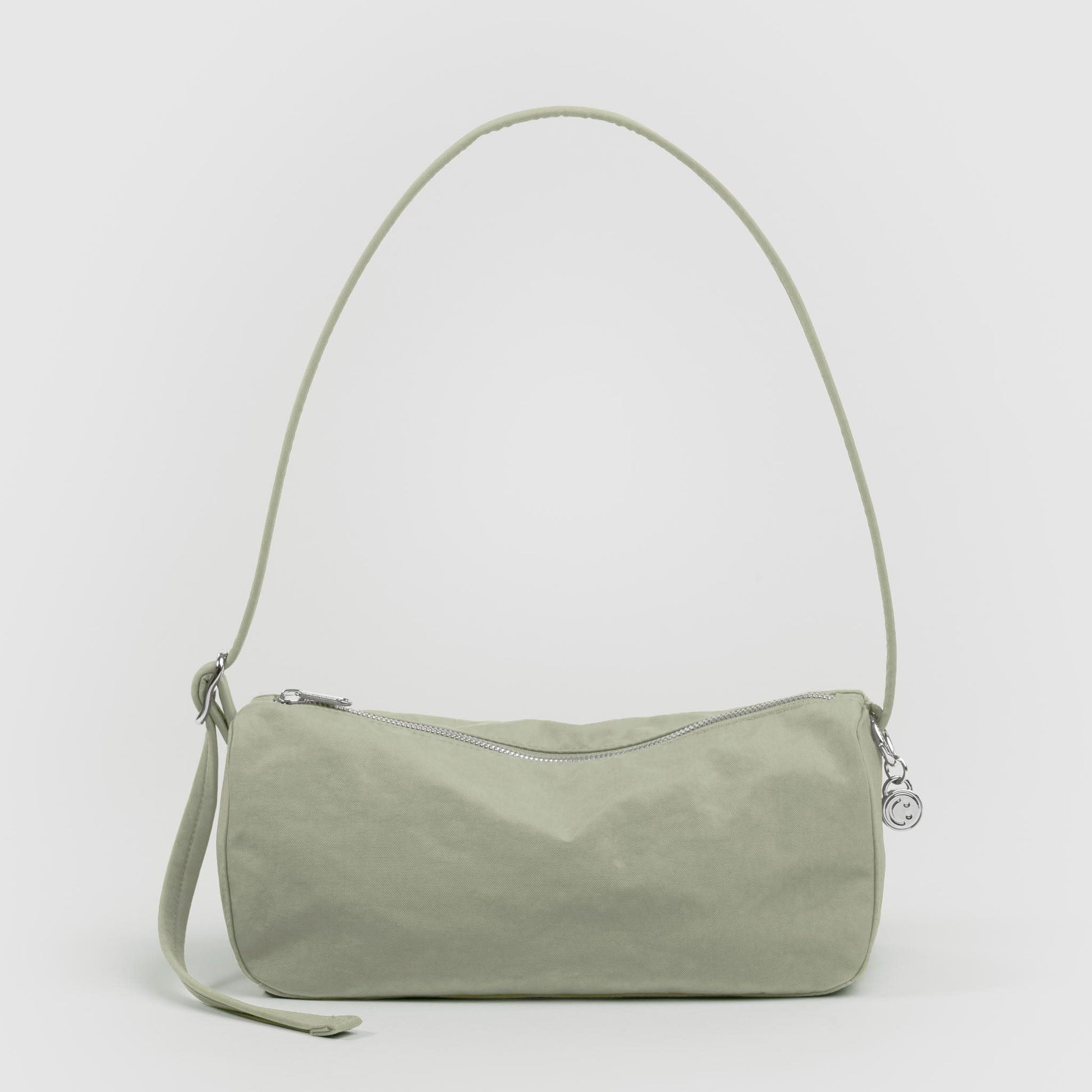 Green handbag with a strap on a white background