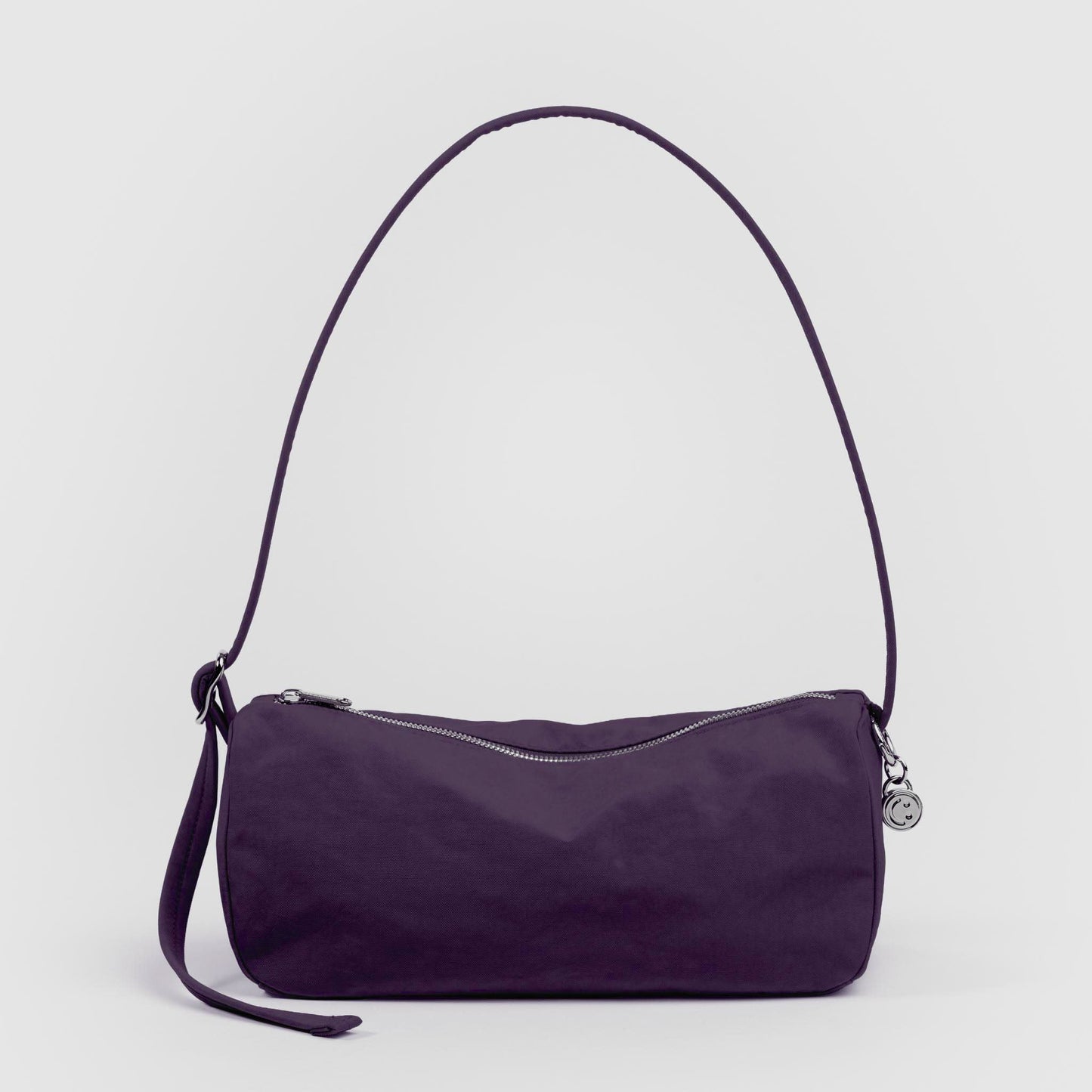 Purple handbag with a strap on a light gray background
