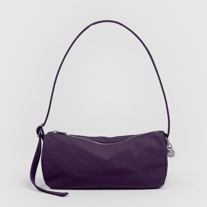 Purple handbag with a strap on a light gray background