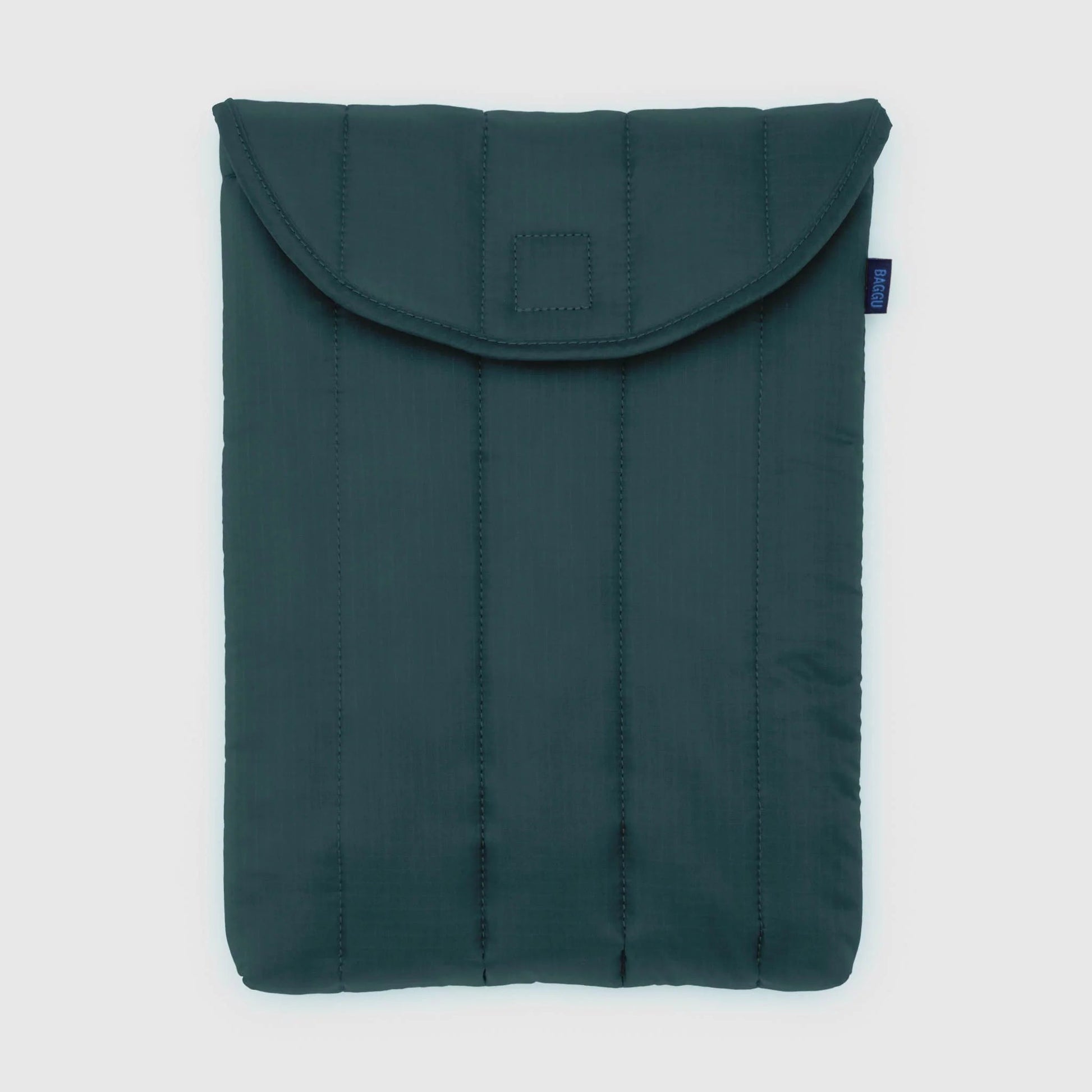 Green quilted laptop sleeve on a light gray background