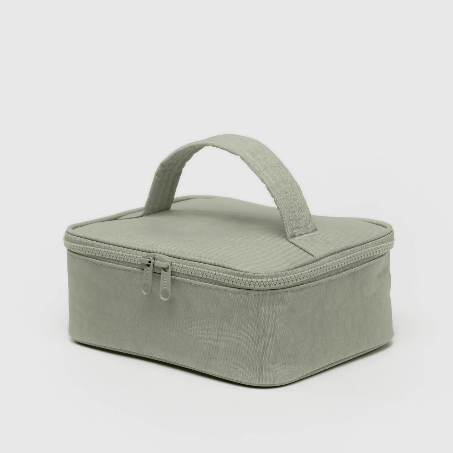 Green rectangular cosmetic case with a handle on a light gray background