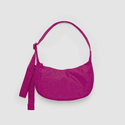 Pink handbag with a strap on a light gray background