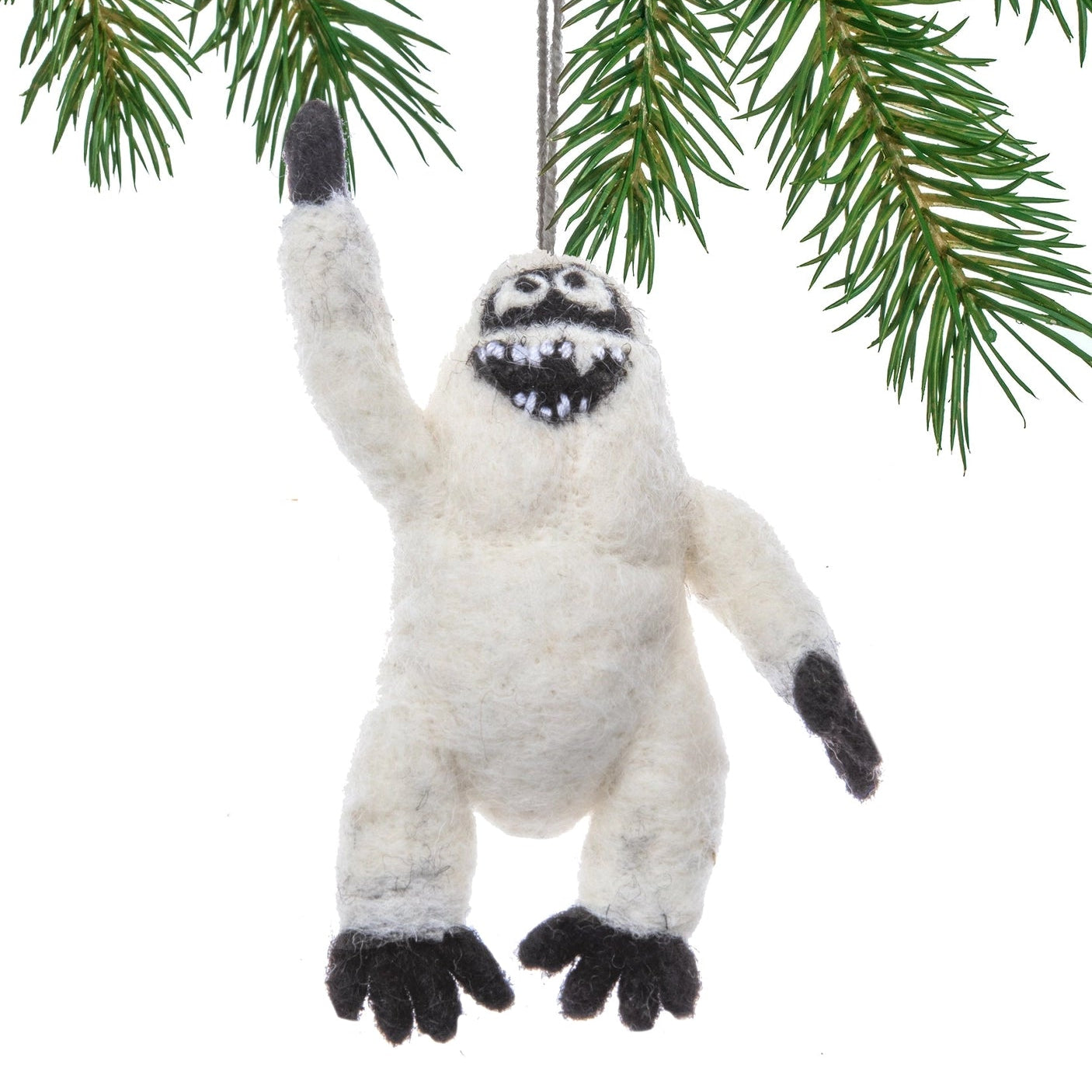 Felt Yeti ornament hanging from a branch