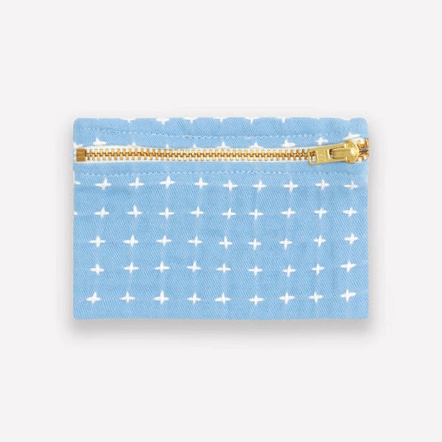 Light blue coin purse with a white cross stitch pattern, featuring a gold zipper.