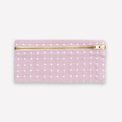 Lilac purple pencil case with white cross stitch pattern and gold zipper on a white background