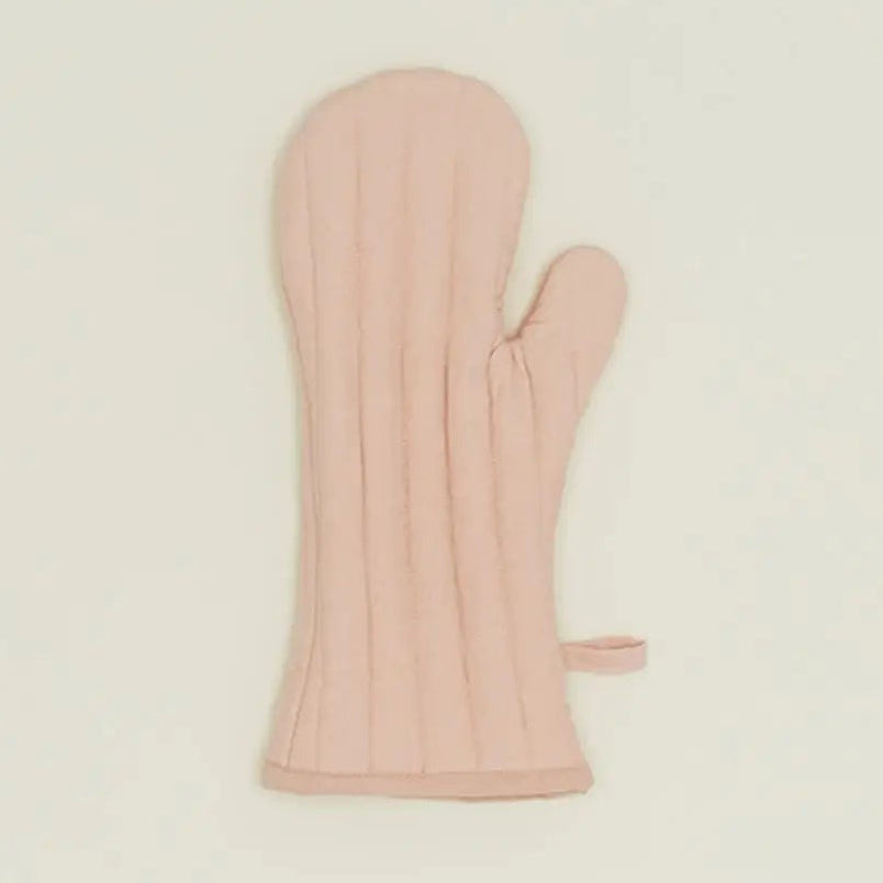 Pink oven mitt on a beige background
