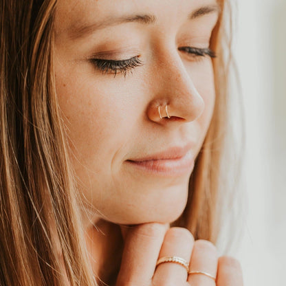 Simple gold double nose cuff on model.