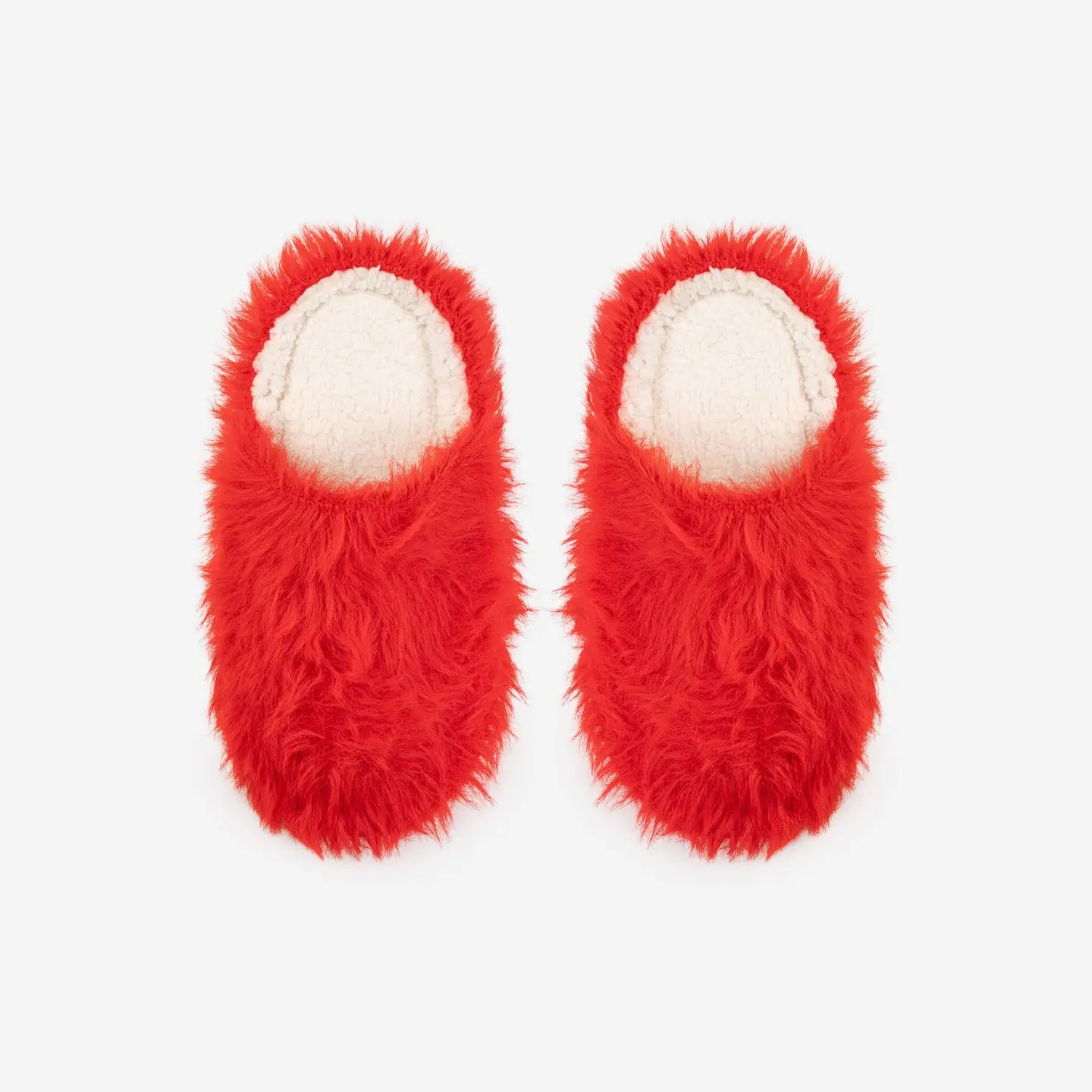 Pair of red furry slippers on a white background