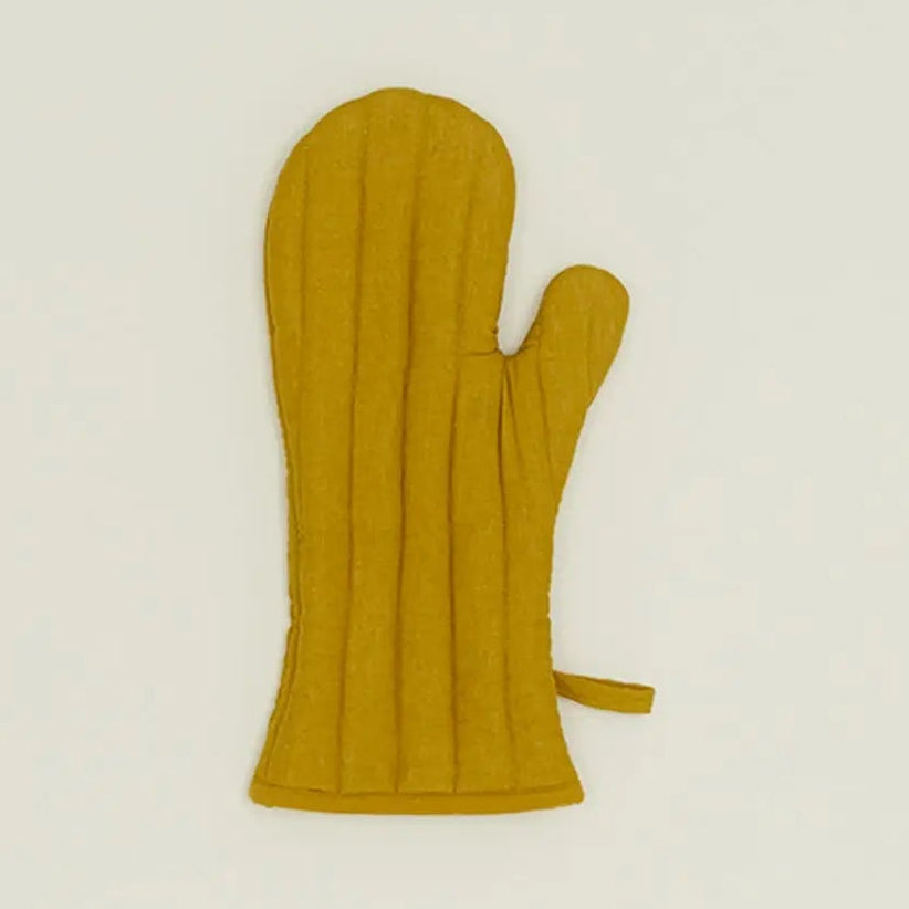 Yellow oven mitt on a beige background