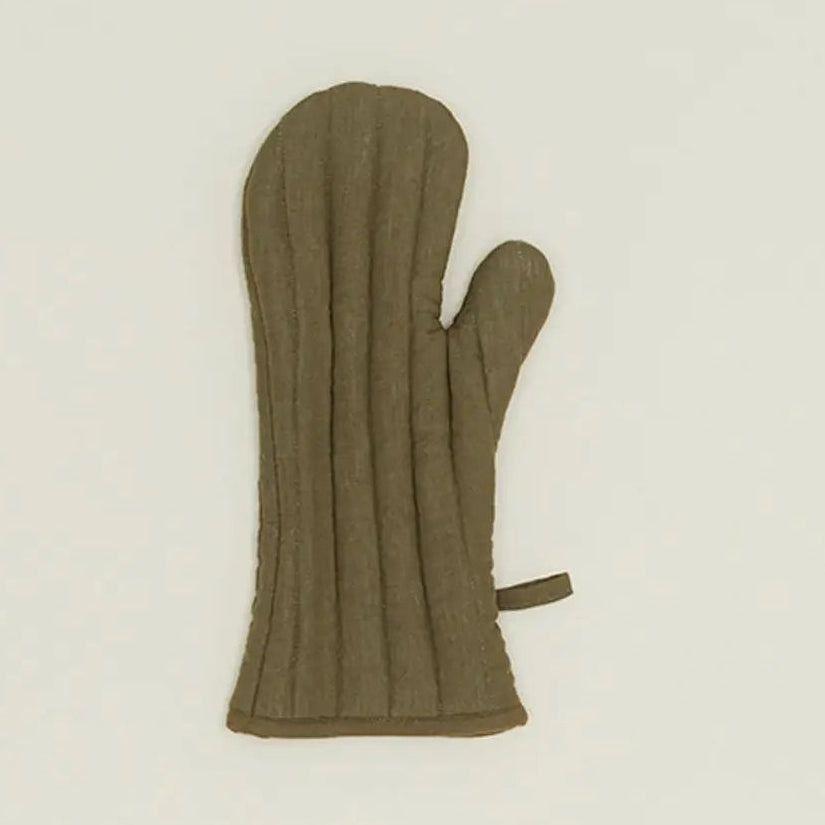 Green oven mitt on a beige background