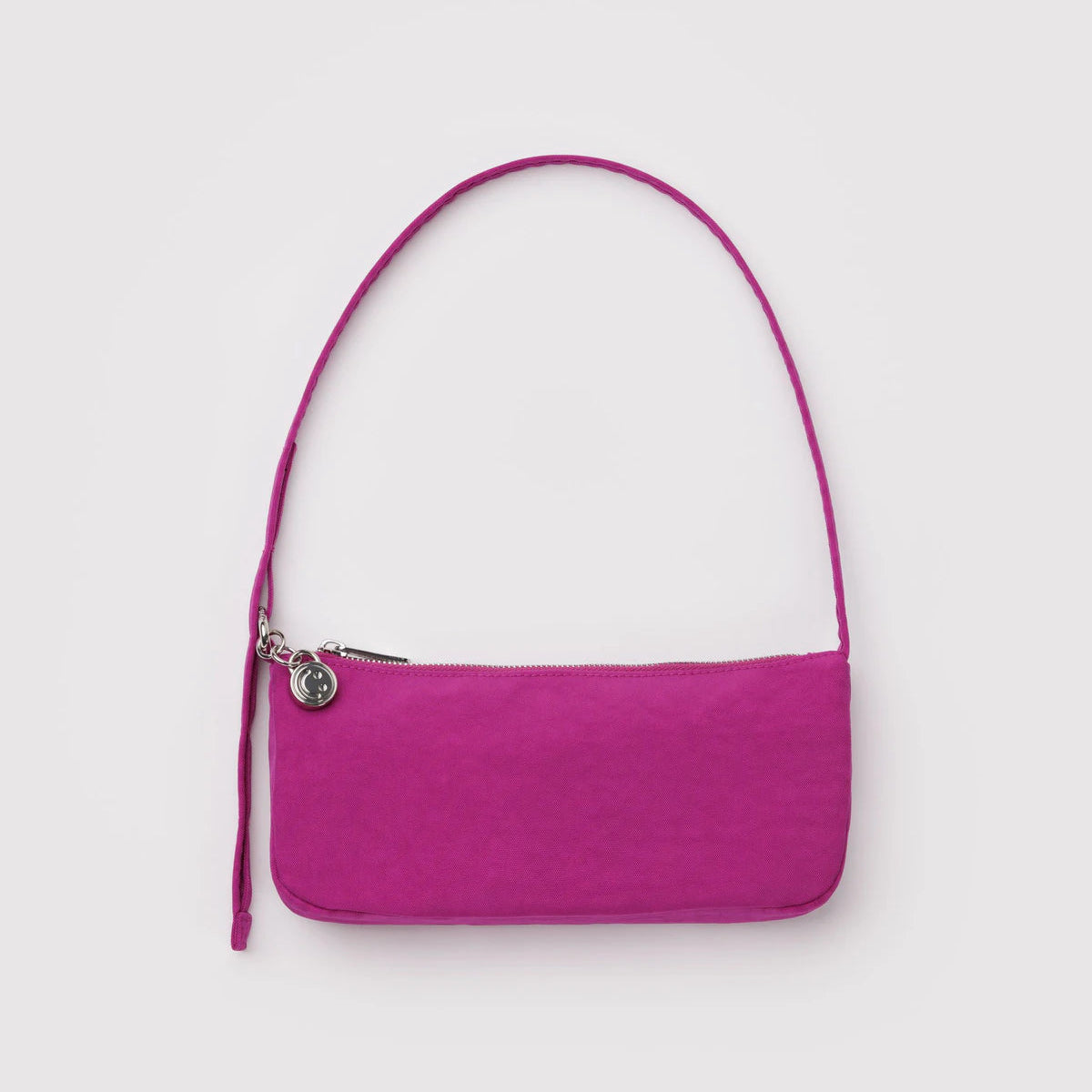 Deep pink handbag with a strap on a light gray background