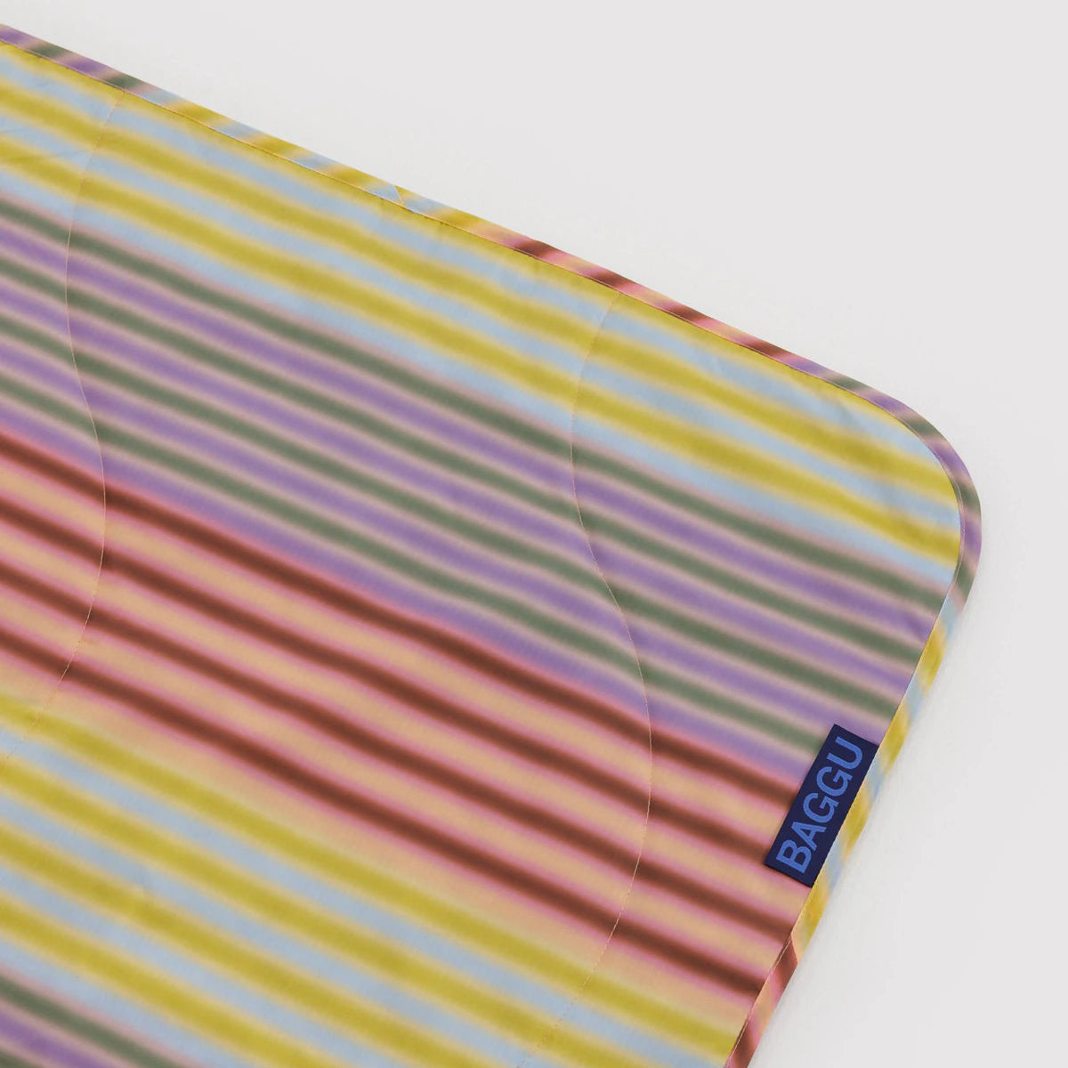 Colorful striped picnic blanket corner on a white background