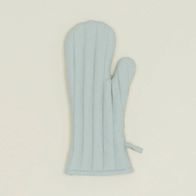 Light blue oven mitt on a beige background