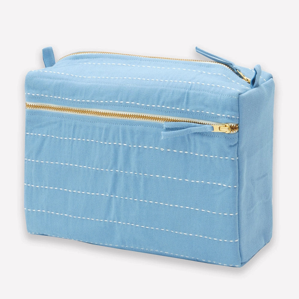 Light blue rectangular toiletry bag with gold zipper on a white background