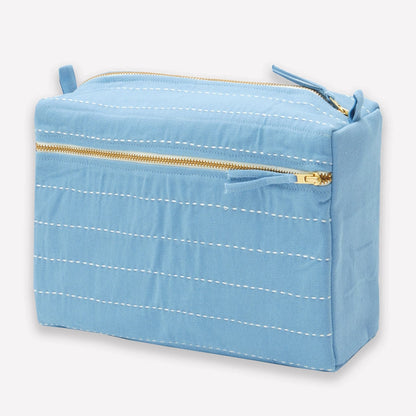 Light blue rectangular toiletry bag with gold zipper on a white background