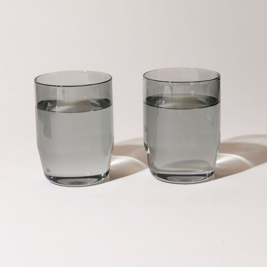 https://neighborlyshop.com/cdn/shop/products/midcentury-12-oz-water-cocktail-glass-set-smoke-grey.jpg?v=1644080013&width=1445